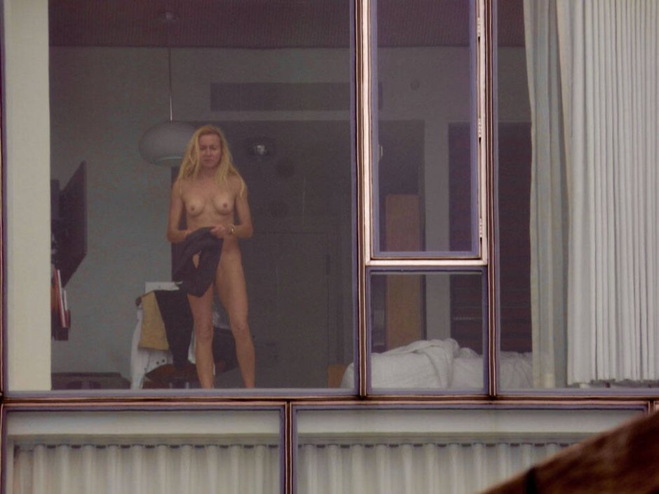 Naked blonde on the windowsill
