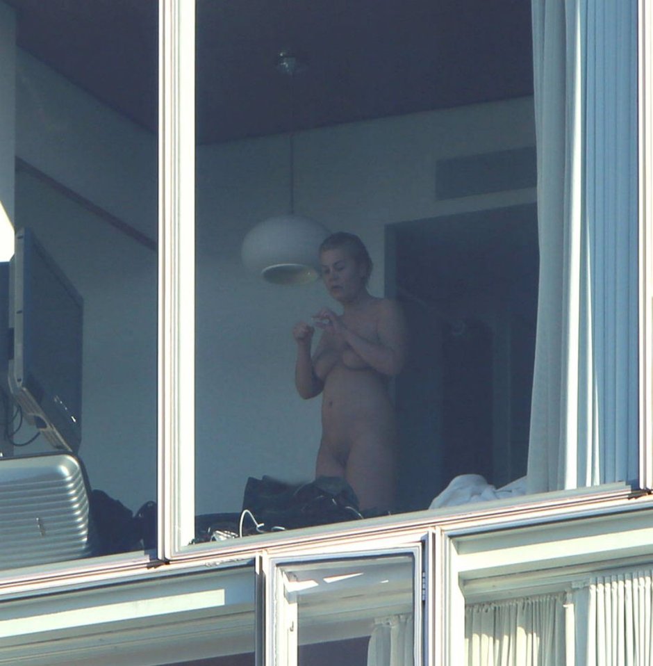 Naked woman near the window