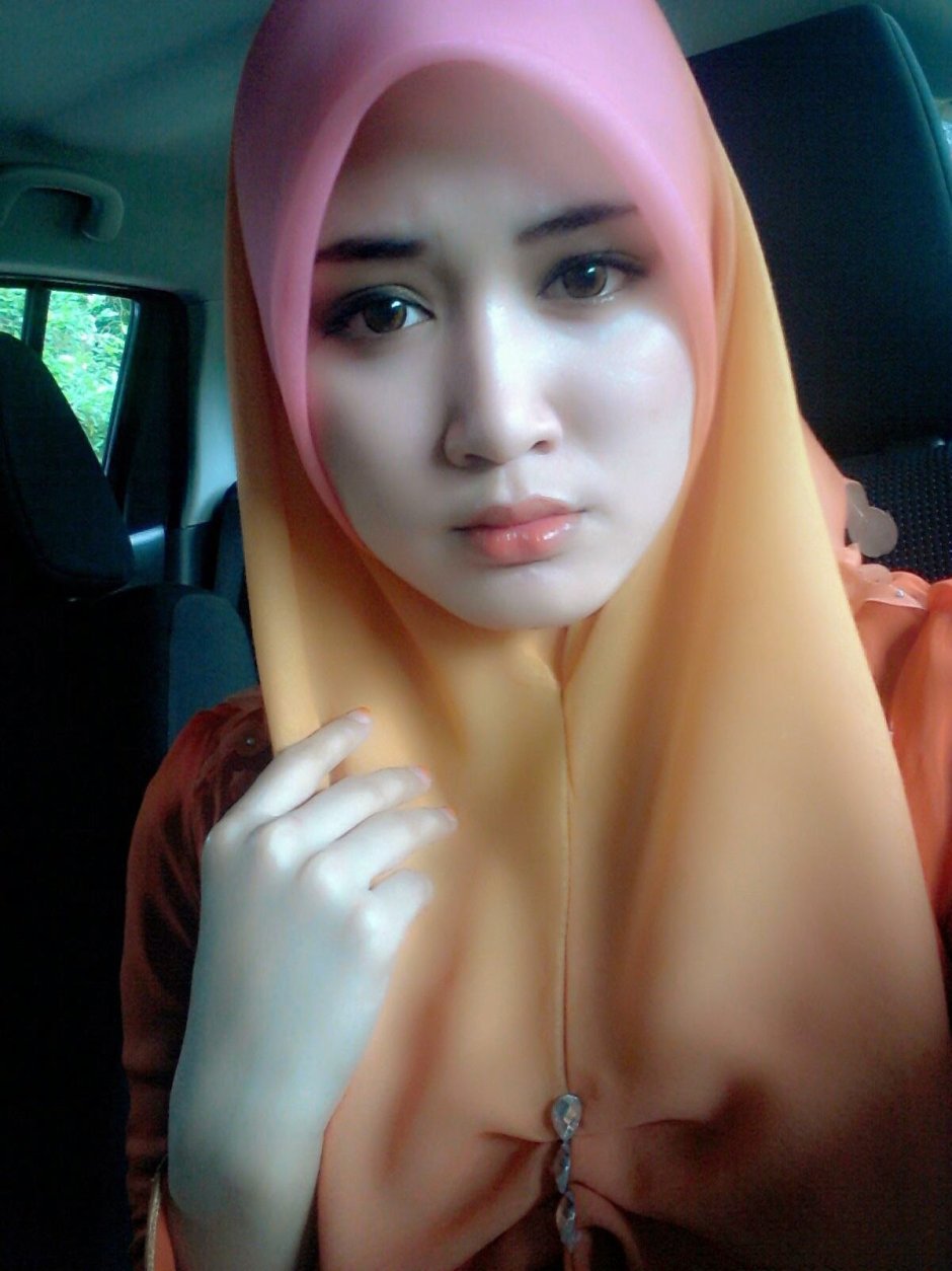 Girl in a hijab shows her chest