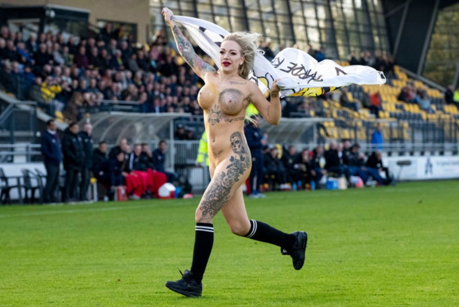 Naked woman on a football field