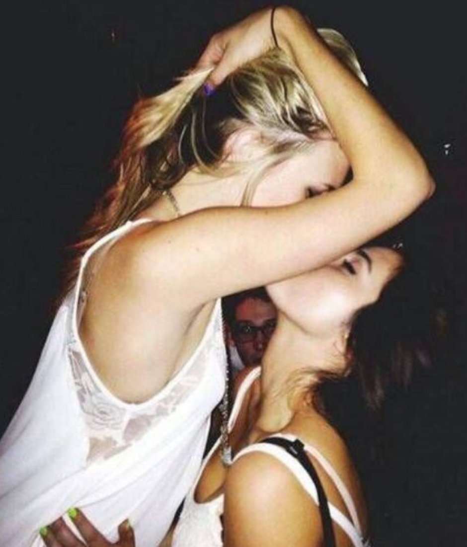 Blonde and brunette kiss