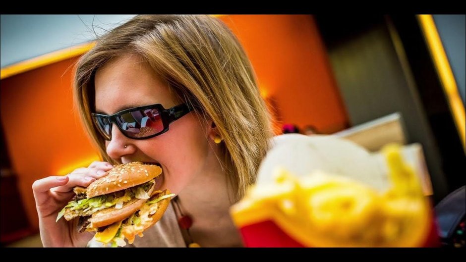 The girl eats in McDonald's