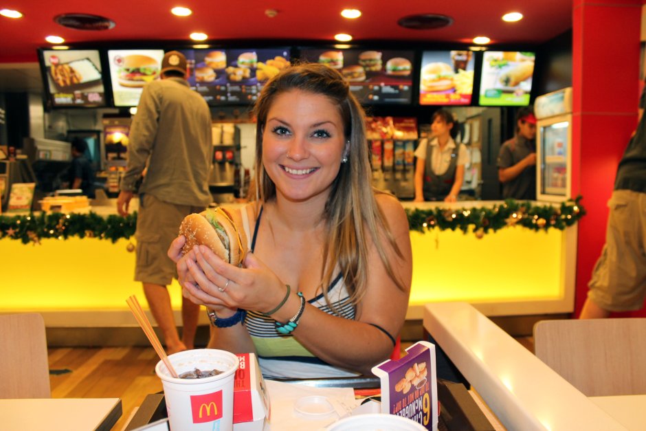 The girl eats in McDonald's