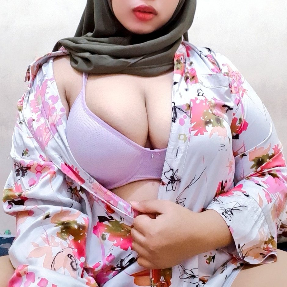 Girl in a hijab shows her chest