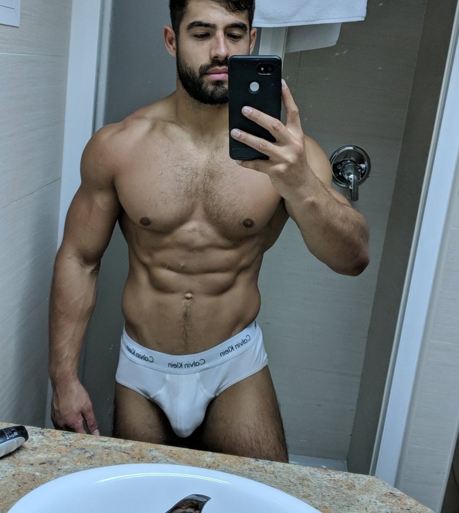 Man in shorts in front of the mirror