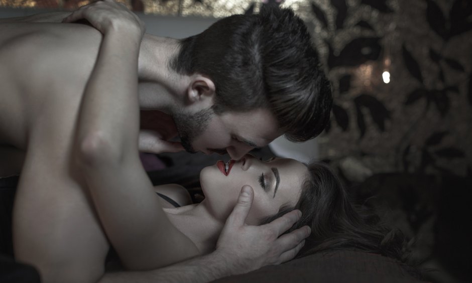 Passionate kiss in bed