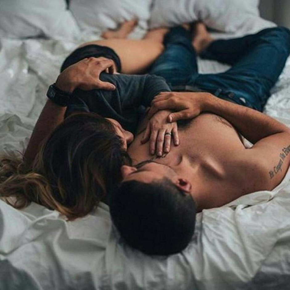 The couple hugs in bed