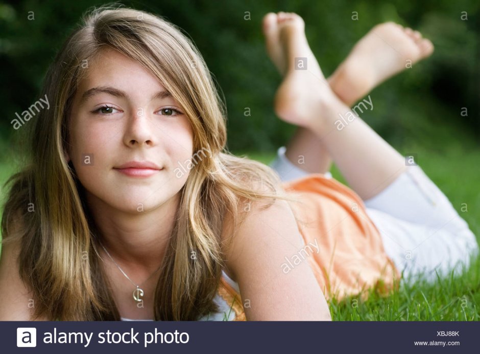 The girl draws on the asphalt