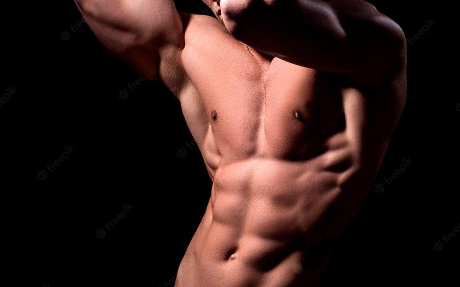 Handsome muscular guy with naked Torso Isolater over a Grey background