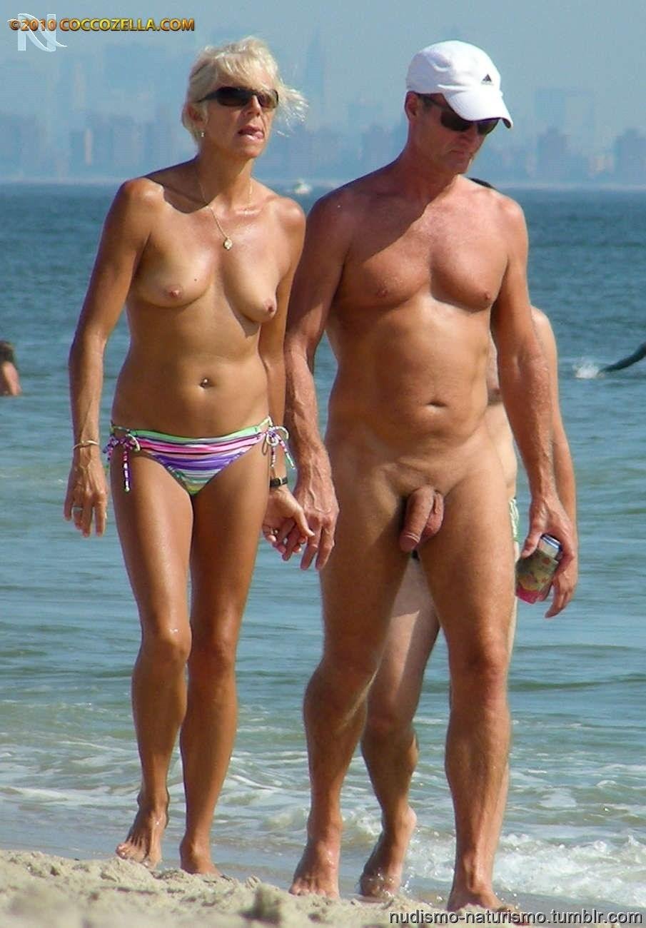 Naked men dressed on the beach