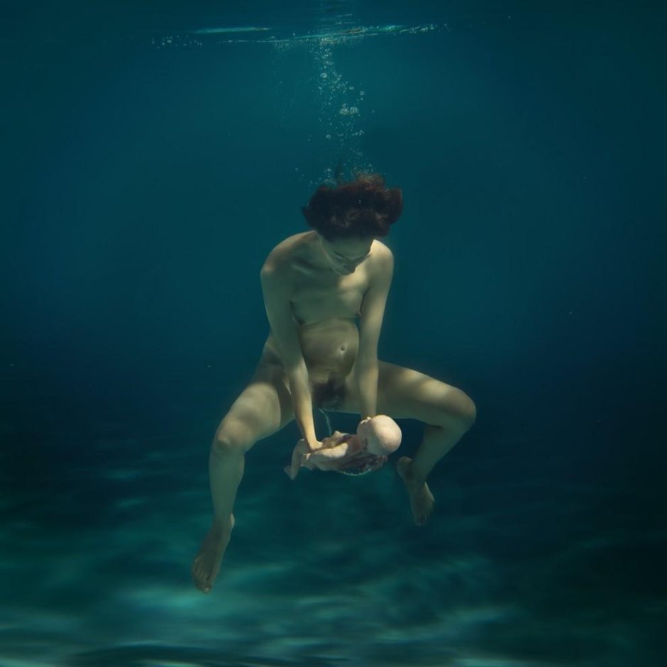 Naked pregnant woman under water