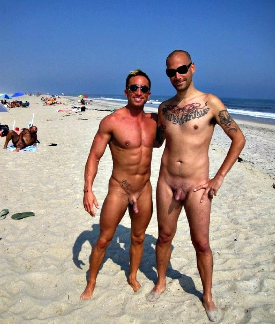 Naked man with a piercing on the beach