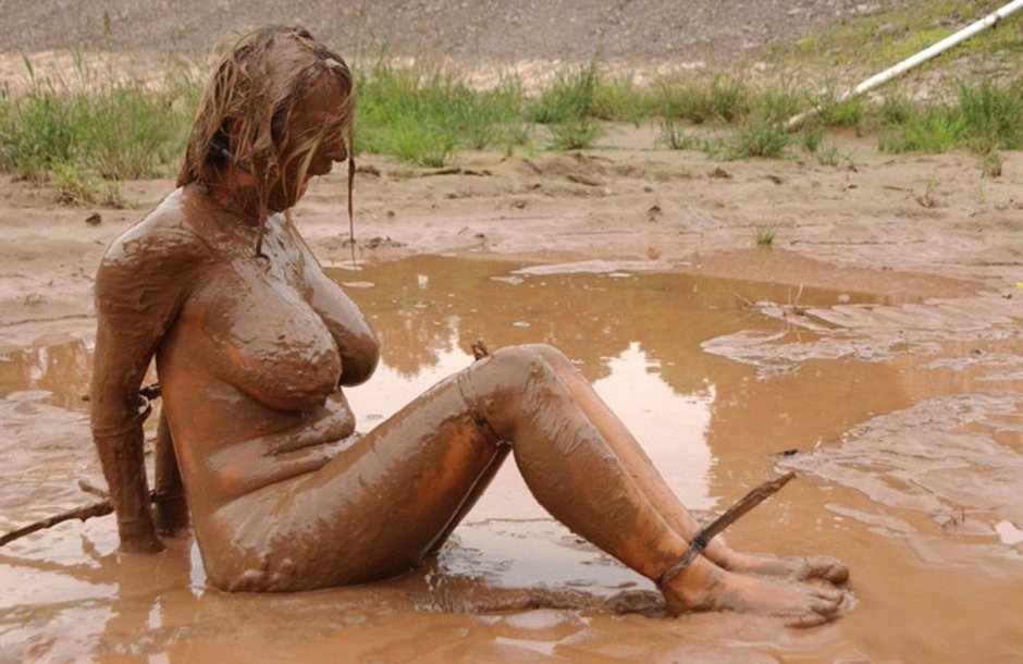 Naked women bathe in mud