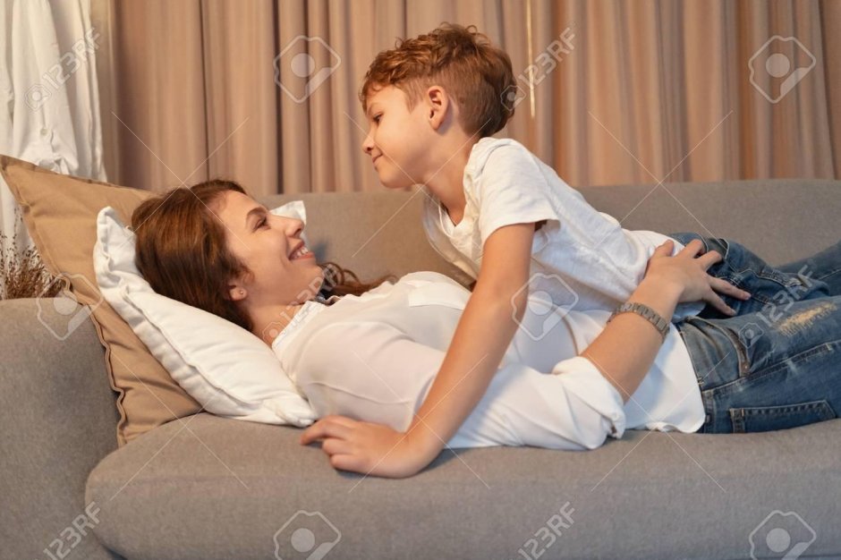 Boy lies on mom