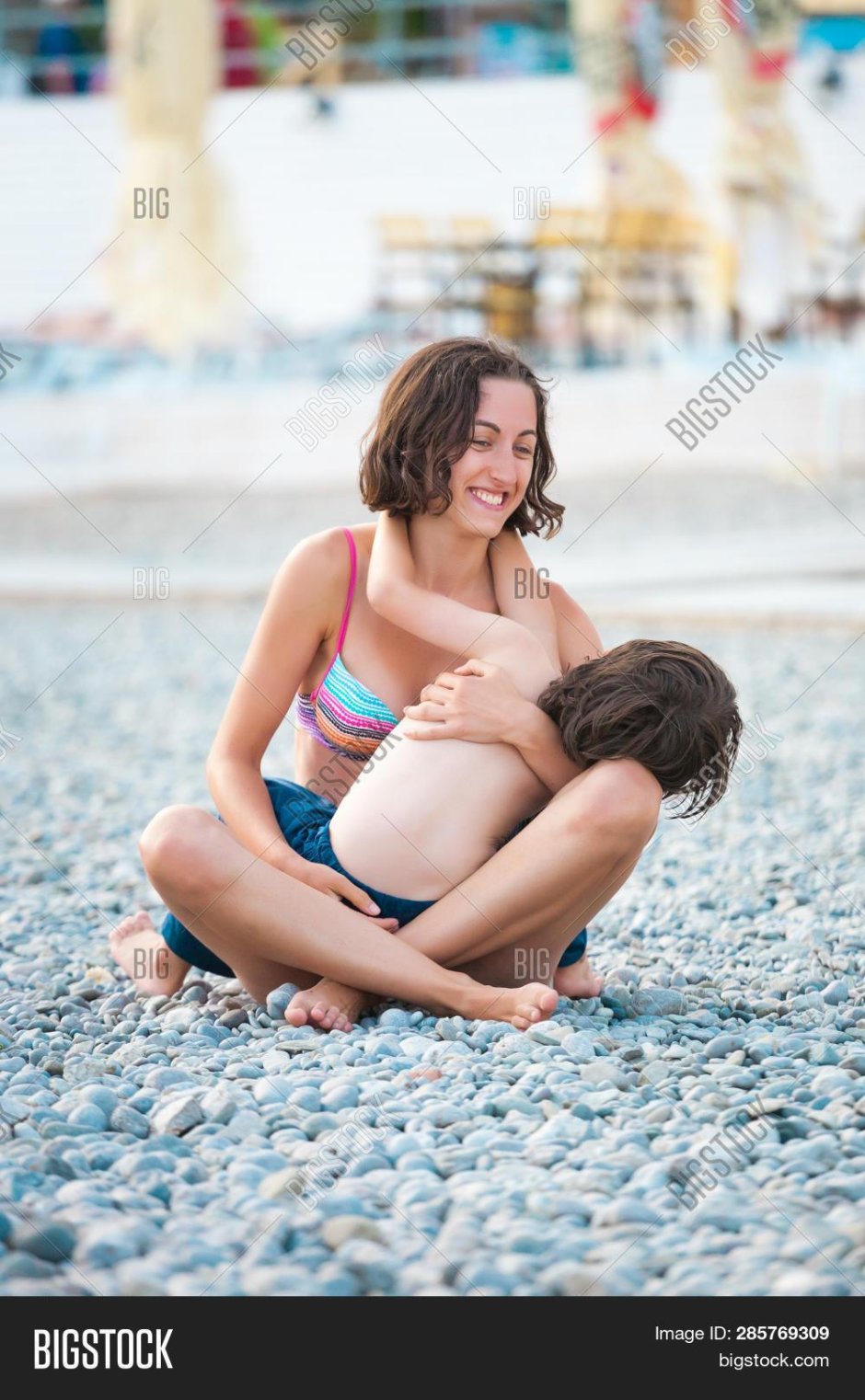Naked woman hugs a child